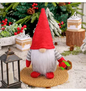 Festive Christmas gnome plush doll with red hat and white beard in a cozy holiday scene