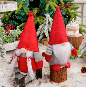 Handmade Christmas gnome plush dolls with red holly hats for festive window decor.