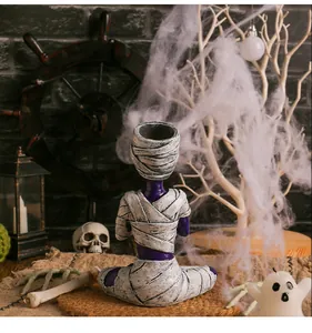 Detailed view of purple meditating mummy resin figurine for Halloween desk decoration