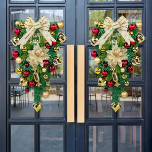 Two luxury Christmas teardrop swags with gold ornaments on a black double door.
