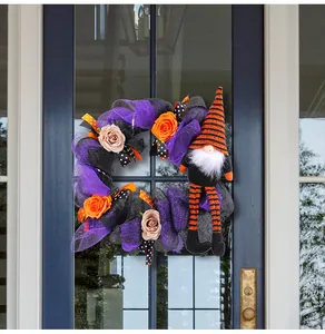 Detail of Halloween gnome wreath with purple mesh and orange roses for door decor