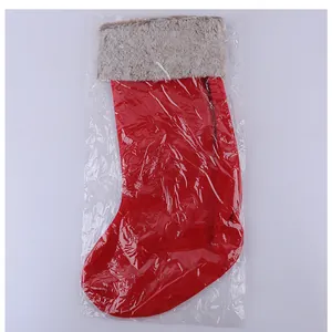 Classic plush red Christmas stocking gift bag shown in protective transparent packaging