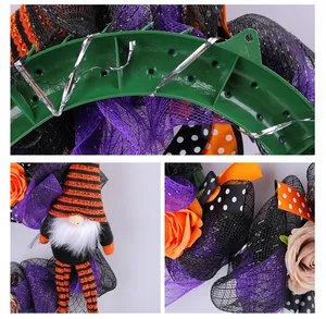 Detailed view of Halloween wreath featuring long-legged gnome and purple mesh decor.
