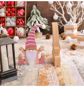 Detailed close-up of a creative pink wooden Christmas gnome figurine with a white beard