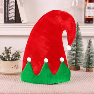 Festive red and green Christmas elf hat with white pom-poms for holiday decoration