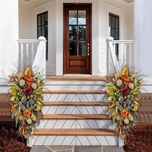 Detail of autumn floral swags with leopard ribbons decorating a white porch staircase