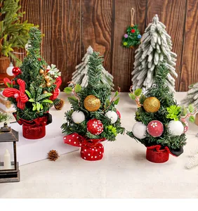 Group of three miniature decorated Christmas trees with red and gold ornaments