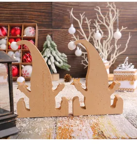Detailed macro shot of two rustic wooden Christmas gnome figurines in a cozy winter holiday setting