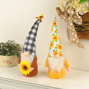 A pair of sunflower themed faceless gnome dolls standing on a mantel for home decor