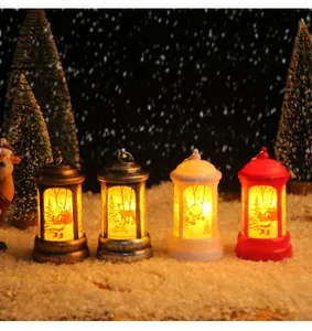 Set of four mini Christmas lanterns with Santa and reindeer designs in a warm snowy scene