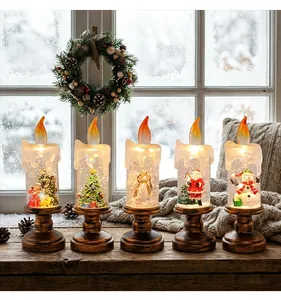 Detailed view of Christmas candle snow globe lights with Santa and snowman scenes