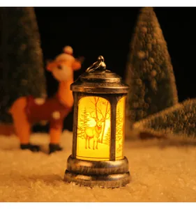 Warm glowing vintage silver Christmas lantern featuring a detailed reindeer forest scene