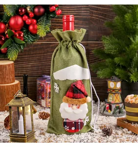 Detailed view of festive green burlap wine bottle cover featuring a 3D Santa Claus figure