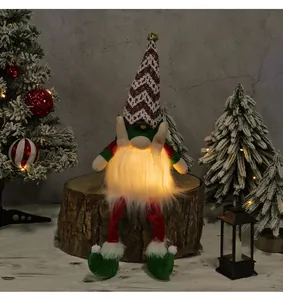 Detailed view of a glowing Christmas gnome with LED beard sitting on a rustic wooden log