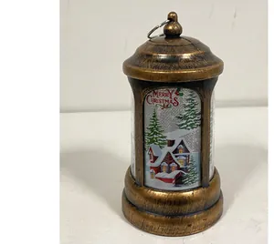 Detailed view of bronze Christmas lantern with snow scene and Merry Christmas text