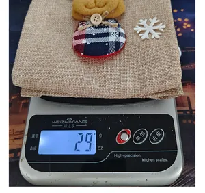Detailed shot of a festive Christmas burlap wine gift bag weighing 29g on a digital scale