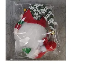 Detailed view of plush Christmas gnome with LED lights in plastic packaging bag