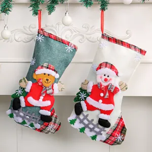 Festive burlap Christmas stockings featuring 3D snowman and bear characters for holiday decor