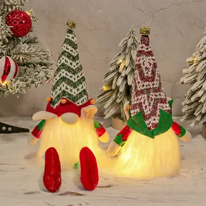 Two glowing Christmas gnomes with LED beards and knitted hats for festive home decor.