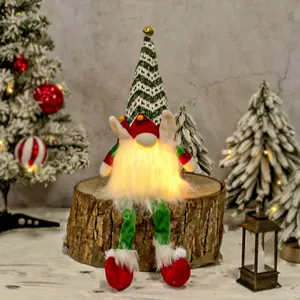 Handmade lighted Christmas gnome plush elf doll sitting on wood for holiday home decor