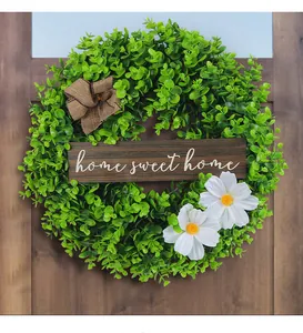 Artificial greenery wreath with home sweet home wood sign and white daisy detail