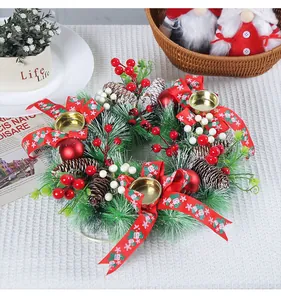 Detail of a Christmas wreath candle holder featuring red berries and pine needles.