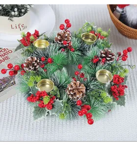 Detail view of artificial Christmas wreath candle holder with red berries and pinecones