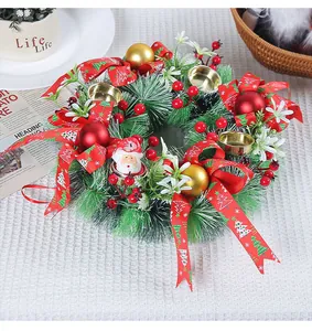 Detailed view of artificial Christmas wreath with candle holders and red berries