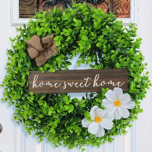 Artificial greenery wreath with Home Sweet Home sign, white daisies and burlap bow