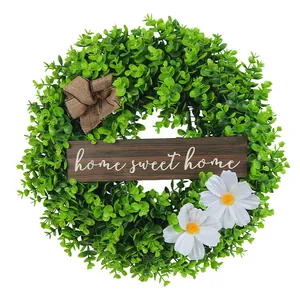 Artificial greenery wreath with white daisy flowers and Home Sweet Home wooden sign
