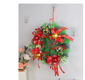 Detailed view of artificial Christmas wreath with red ribbons and pine needles