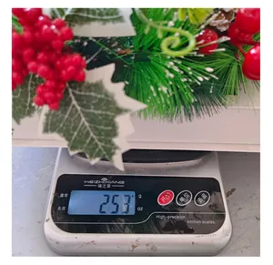 Weight measurement of creative Christmas wreath with red berries and green pine needles