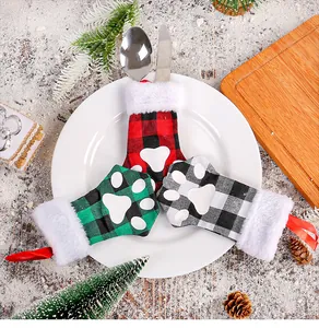 Detail view of cat paw plaid cutlery covers for Christmas table setting.