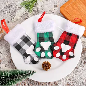 Set of three Christmas cat paw cutlery holders with buffalo plaid patterns and fur trim.