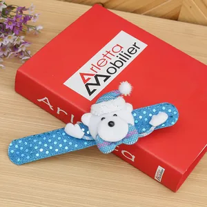 Close-up of a blue Christmas slap bracelet featuring a cute white bear with a Santa hat.