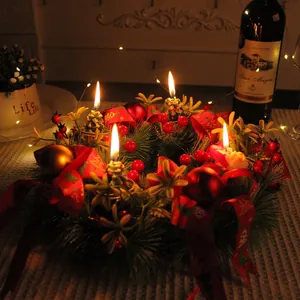 Festive Christmas wreath candle holder with red berries and pine needles for table decor