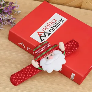 Detailed view of a festive red sequin Christmas Santa slap bracelet on a decorative red book
