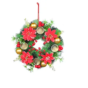 Festive Christmas wreath candle holder featuring red poinsettias and golden ornaments.