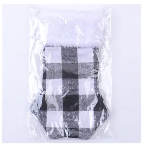 Macro view of Christmas cat claw cutlery cover in black and white checkered fabric