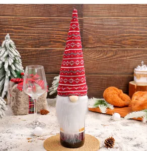 Detail showing a knitted gnome wine bottle cover with a long red hat and white beard
