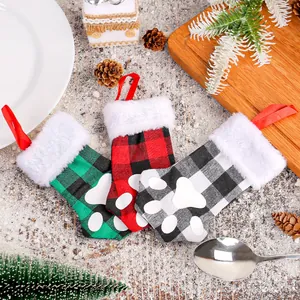 Festive Christmas cat paw cutlery holders in red green black buffalo plaid pattern.