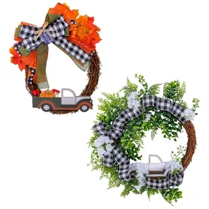Set of two decorative wreaths with autumn maple leaves and evergreen foliage for door