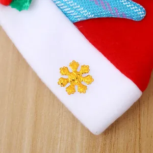 Detailed close-up of a kids Christmas hat featuring a golden snowflake accessory and red felt material