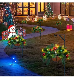 Detailed view of artificial Christmas hanging baskets with LED lights and ornaments in garden