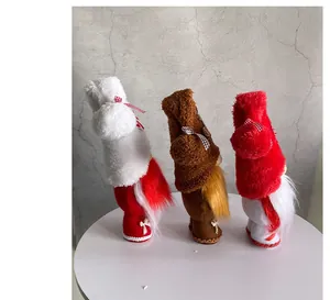 Detail view of three festive plush Christmas gnome dolls on a minimalist table