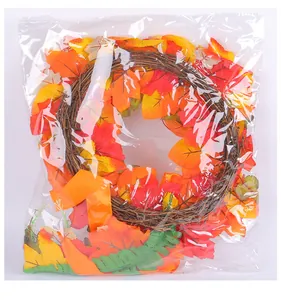 Detailed view of the autumn harvest maple leaf wreath packed in a clear plastic bag