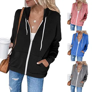 Detail of solid color zip-up hooded sweatshirt showing black, pink, blue, and gray colors.