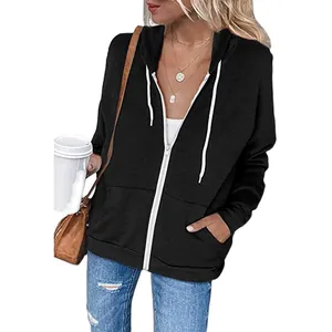 Close-up shot of a women's black zip-up hoodie with white drawstrings and front pockets.
