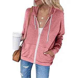 Detailed view of women's pink zip-up hoodie featuring white drawstrings and pockets
