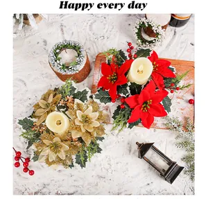Close-up of red and gold Christmas poinsettia candle ring ornaments and decorations